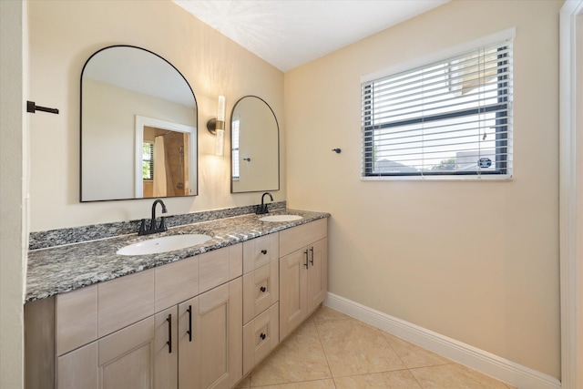 bathroom with tile patterned floors and vanity