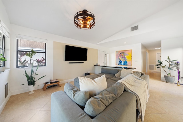 living room featuring light tile patterned floors and vaulted ceiling