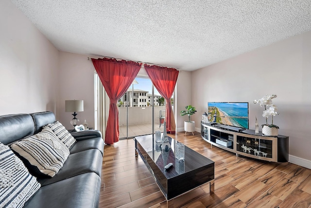 living room with hardwood / wood-style floors and a textured ceiling