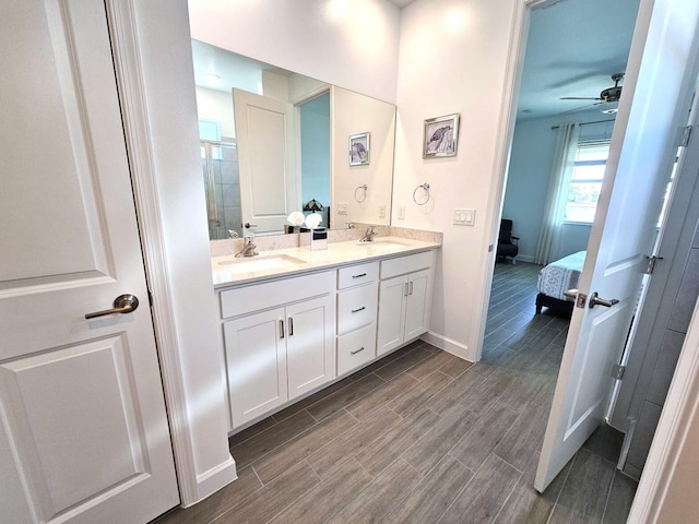 bathroom featuring vanity, ceiling fan, and a shower with door