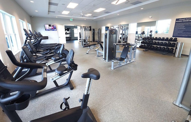 workout area with a paneled ceiling and ceiling fan