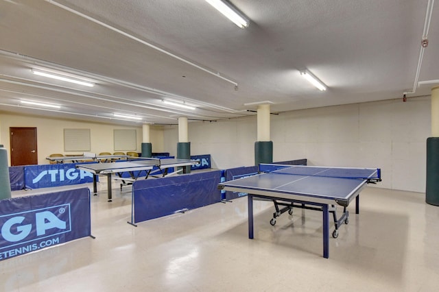 recreation room featuring a textured ceiling