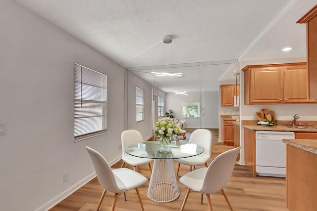 dining room with light hardwood / wood-style floors and sink