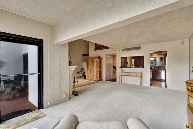 carpeted living room featuring a textured ceiling and a premium fireplace