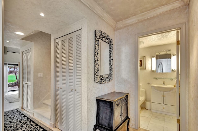 bathroom with vanity, toilet, and crown molding