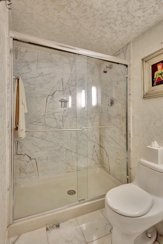 bathroom featuring an enclosed shower, tile patterned flooring, and toilet