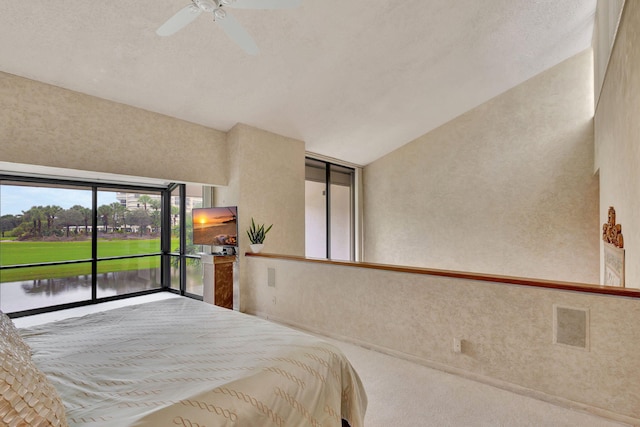 bedroom featuring ceiling fan, a textured ceiling, vaulted ceiling, access to outside, and carpet