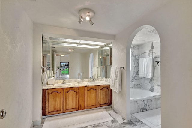 bathroom with vanity and tiled bath