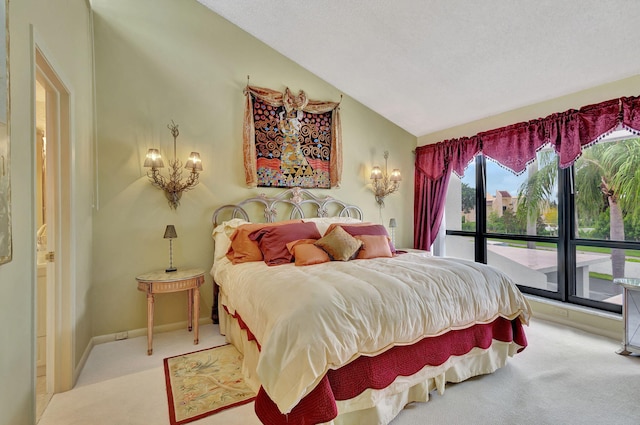 bedroom with a textured ceiling, light carpet, and vaulted ceiling