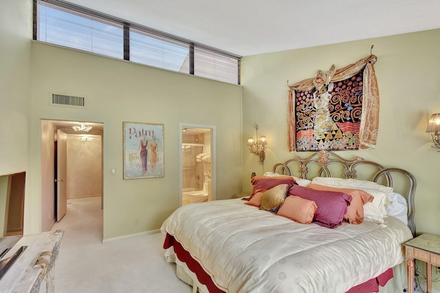 carpeted bedroom with ensuite bathroom