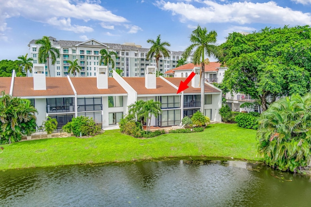 exterior space featuring a yard and a water view