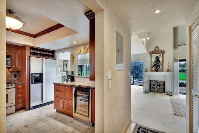 kitchen with wine cooler, a healthy amount of sunlight, light colored carpet, and stainless steel appliances