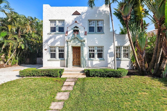 mediterranean / spanish-style house featuring a front lawn