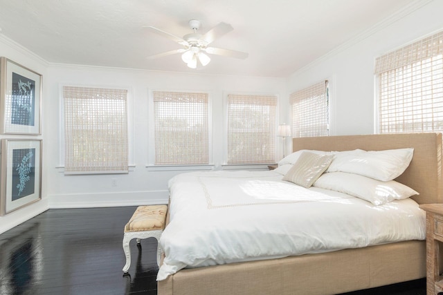 bedroom featuring ceiling fan, crown molding, and dark wood-type flooring