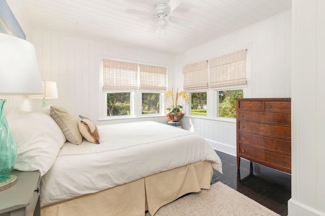 bedroom with ceiling fan, dark hardwood / wood-style flooring, and wood ceiling