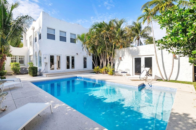 view of pool with french doors and a patio