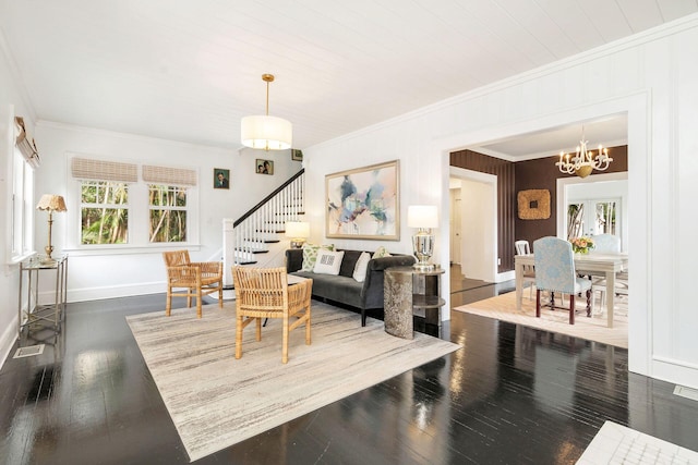 living room featuring crown molding, dark hardwood / wood-style floors, and a notable chandelier