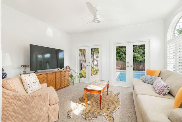 living room featuring crown molding, french doors, ceiling fan, and light colored carpet