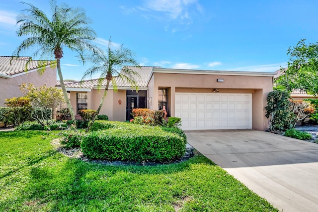 view of front of home featuring a front lawn and a garage