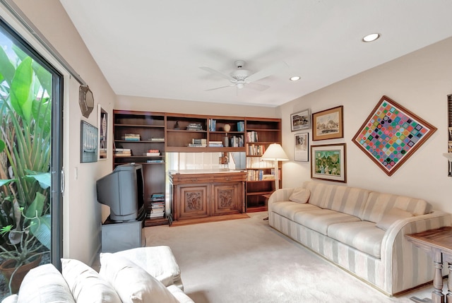 living room with ceiling fan and light carpet