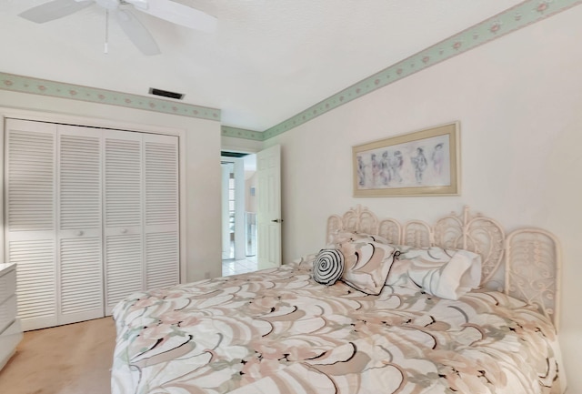 carpeted bedroom featuring ceiling fan and a closet