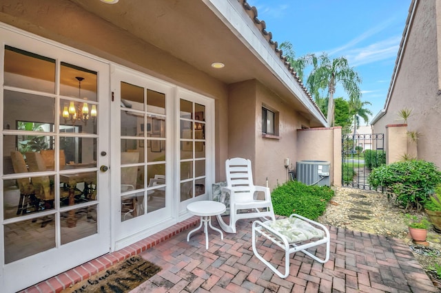 view of patio / terrace featuring french doors and cooling unit