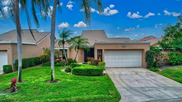 view of front of home with a garage and a front lawn