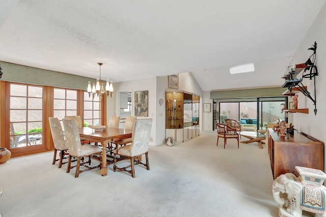 dining room with light carpet, a chandelier, and lofted ceiling