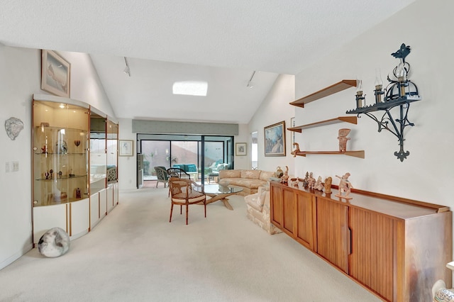 carpeted living room featuring lofted ceiling