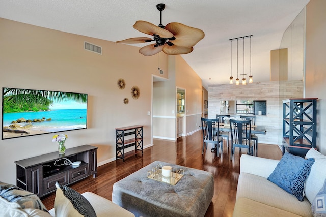 living room featuring ceiling fan, high vaulted ceiling, and dark hardwood / wood-style floors