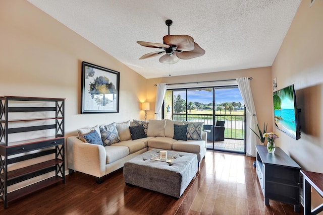 living room with dark hardwood / wood-style floors, ceiling fan, lofted ceiling, and a textured ceiling