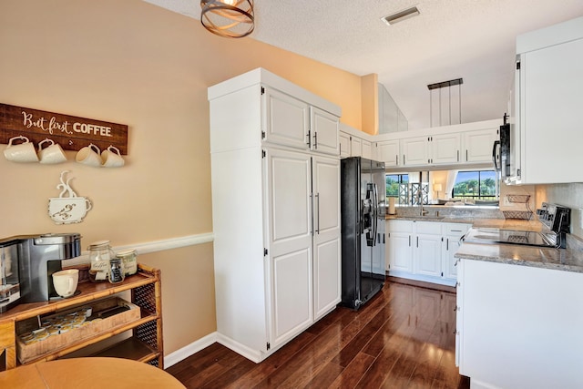 kitchen with dark hardwood / wood-style flooring, white cabinetry, and black refrigerator with ice dispenser