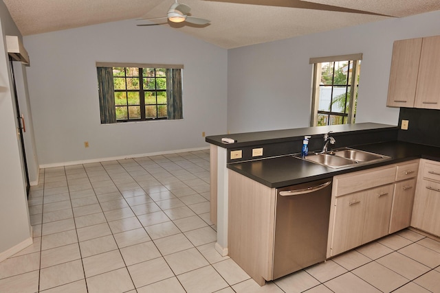 kitchen with stainless steel dishwasher, kitchen peninsula, sink, and light brown cabinetry