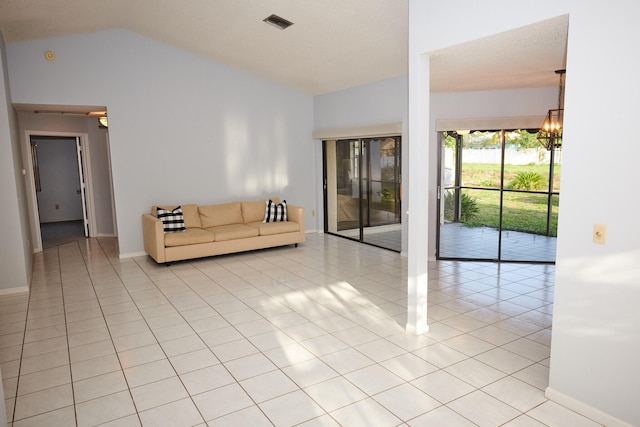 unfurnished living room with vaulted ceiling, a notable chandelier, and light tile patterned flooring