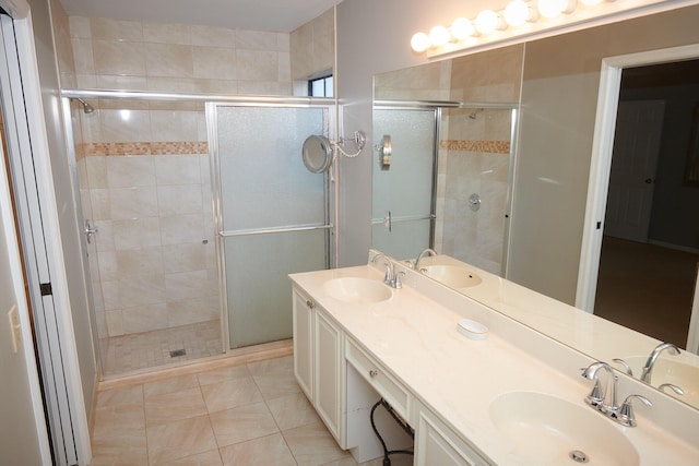 bathroom with tile patterned flooring, vanity, and an enclosed shower