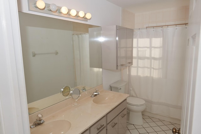 bathroom with tile patterned flooring, vanity, toilet, and curtained shower