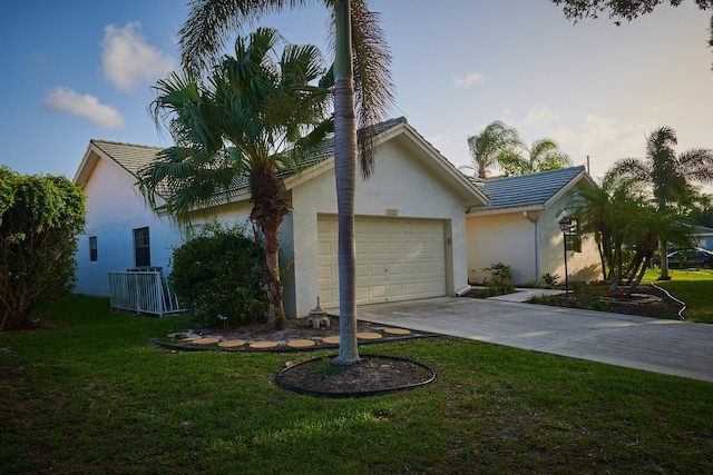 view of front of property with a yard and a garage