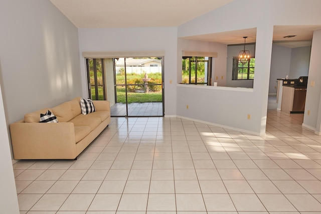 tiled living room with an inviting chandelier and lofted ceiling