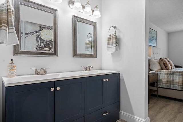 bathroom featuring vanity, wood-type flooring, and a textured ceiling