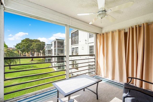 sunroom / solarium featuring ceiling fan