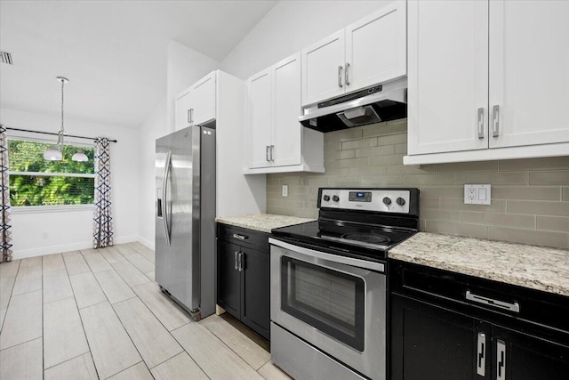 kitchen featuring hanging light fixtures, stainless steel appliances, tasteful backsplash, vaulted ceiling, and white cabinets