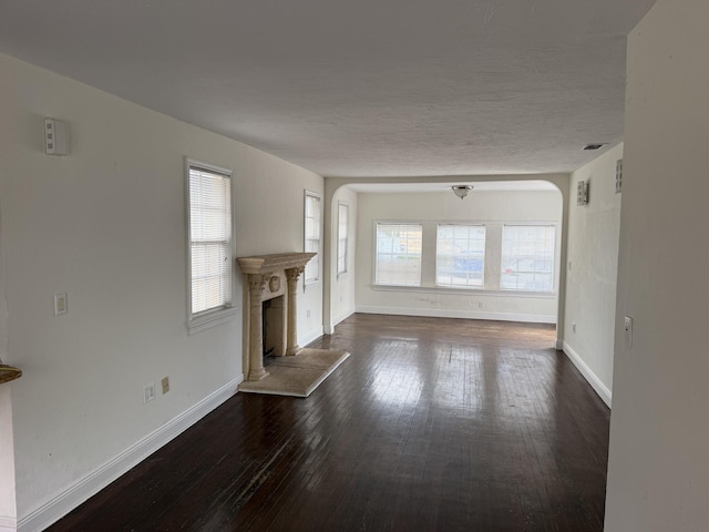 unfurnished living room featuring dark wood-type flooring