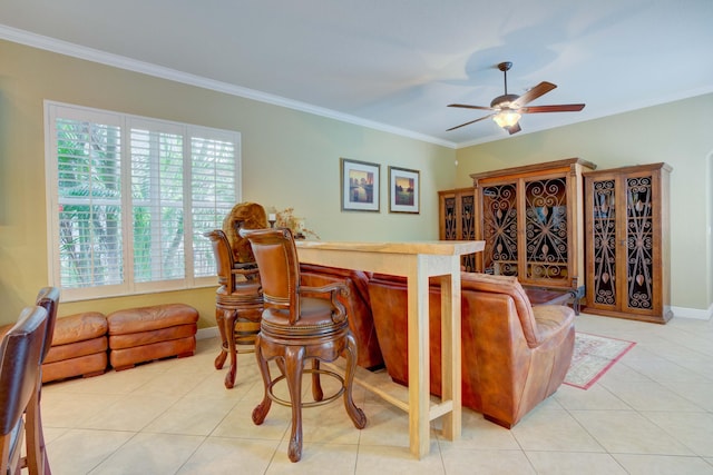 tiled living room with ceiling fan, plenty of natural light, and ornamental molding