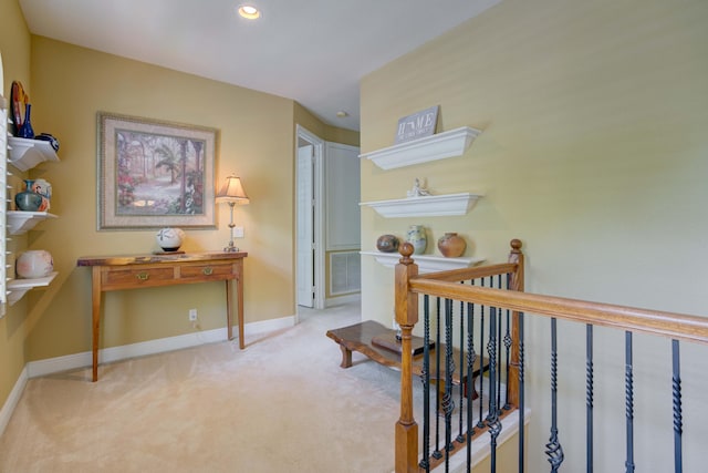 hallway with light colored carpet