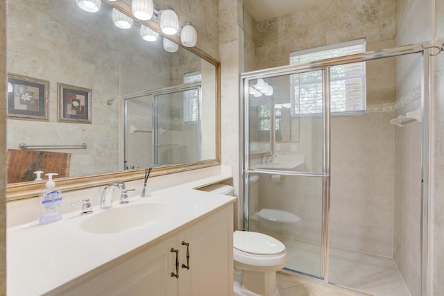 bathroom with tile patterned flooring, vanity, toilet, and a shower with door