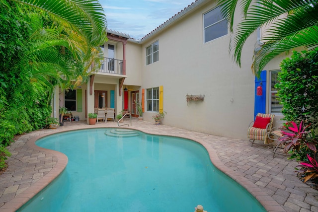 view of swimming pool featuring a patio area