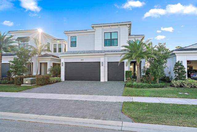 view of front of house featuring a front yard and a garage