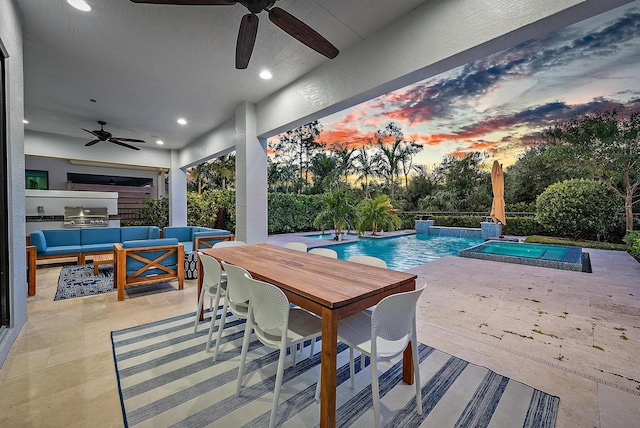 pool at dusk featuring ceiling fan, an outdoor kitchen, an outdoor living space, an in ground hot tub, and a patio