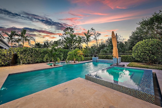 view of pool at dusk