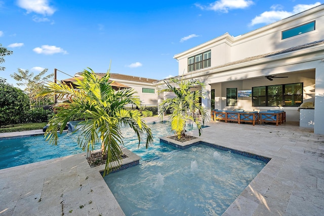 view of swimming pool featuring a patio area, ceiling fan, pool water feature, and an outdoor hangout area